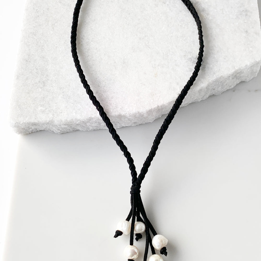 
                      
                        White Freshwater Pearl Necklace on Braided Black Vegan Suede.  Strong Secure Magnetic Clasp for Easy Wear. 
                      
                    