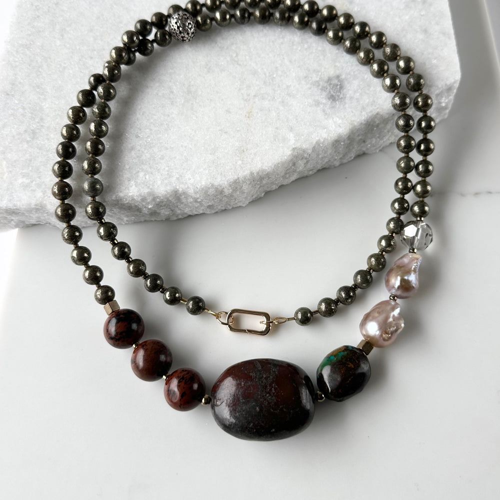 This Unique Long (40”) Necklace Features a combination of Brown Turquoise, Mahogany Obsidian, Pyrite, Crystal, Baroque Freshwater Pearls, finished with Silver and Gold Accents and a Charm Clasp. Wear it Long or Double it up!