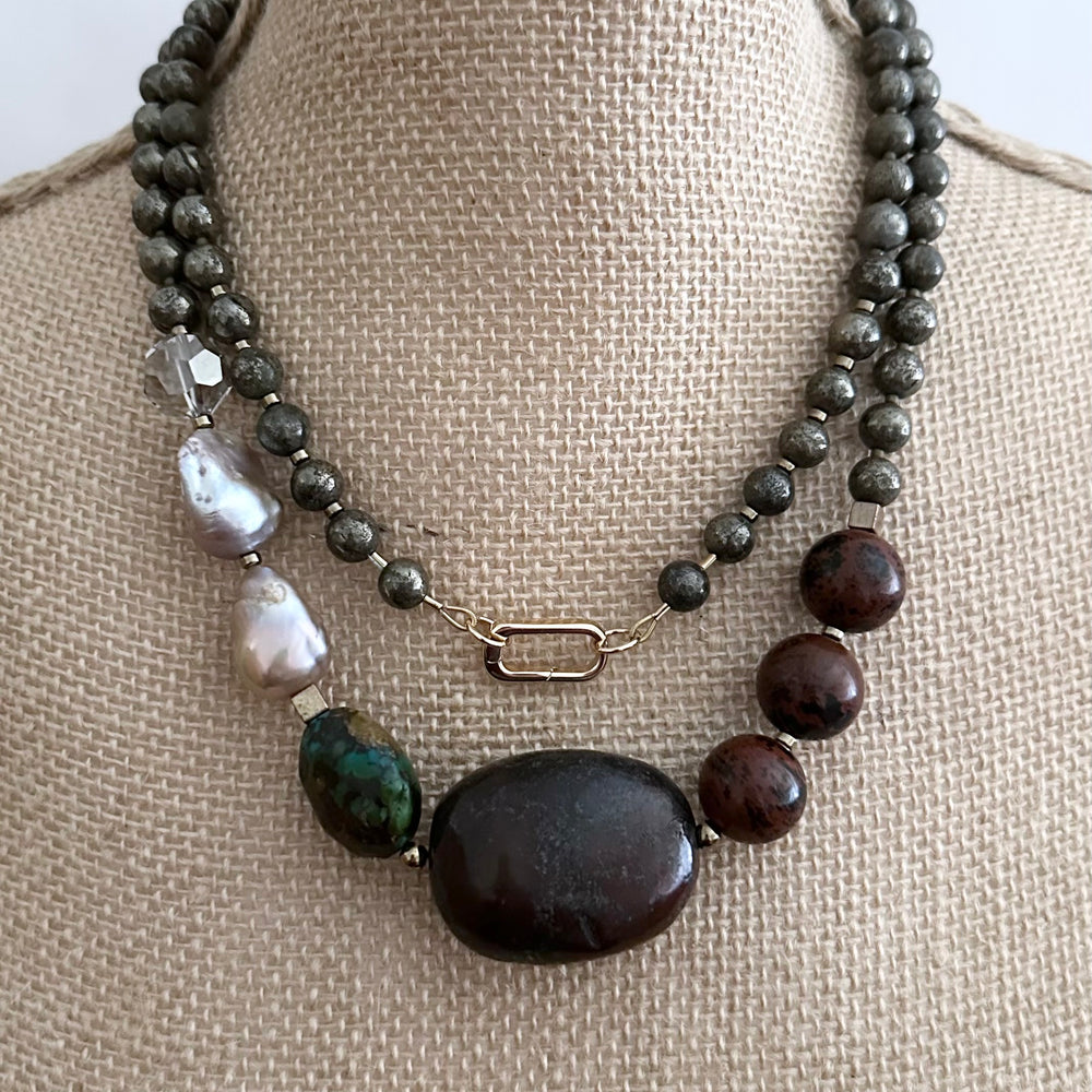 
                      
                        This Unique Long (40”) Necklace Features a combination of Brown Turquoise, Mahogany Obsidian, Pyrite, Crystal, Baroque Freshwater Pearls, finished with Silver and Gold Accents and a Charm Clasp. Wear it Long or Double it up!
                      
                    