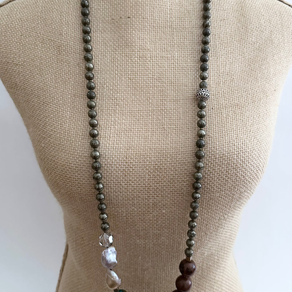 
                      
                        This Unique Long (40”) Necklace Features a combination of Brown Turquoise, Mahogany Obsidian, Pyrite, Crystal, Baroque Freshwater Pearls, finished with Silver and Gold Accents and a Charm Clasp. Wear it Long or Double it up!
                      
                    