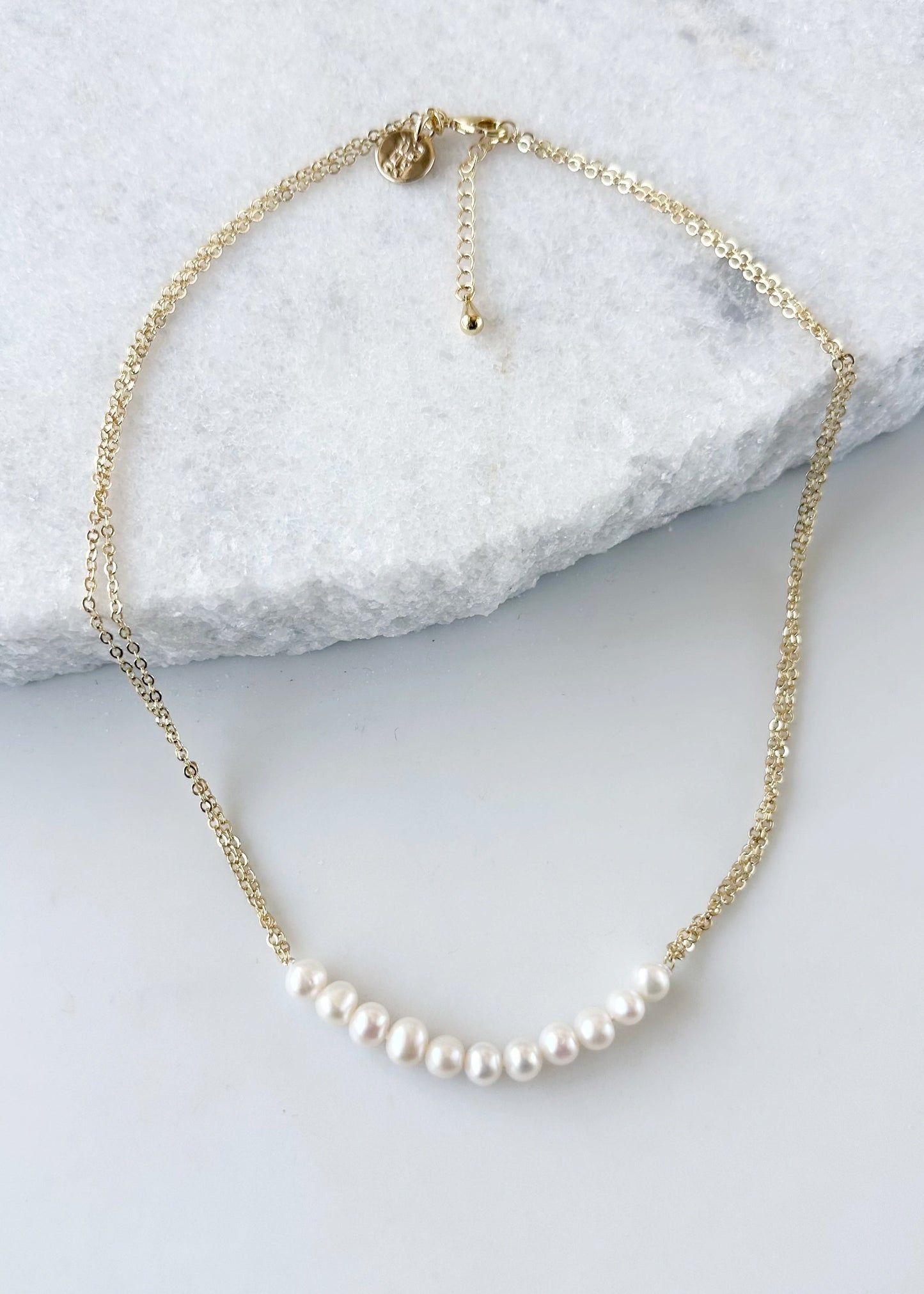 Designed in Canada, the 18” Caroline Necklace (with Extender) features a row (2.5” long) of Pretty Freshwater Pearls on Two Strands on Delicate Gold-Plated Chain.