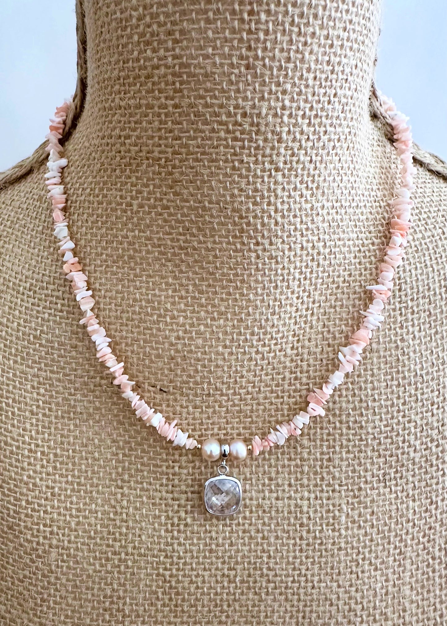 Designed and made in Canada, this Limited Edition 18.25” Necklace features coral with a clear Crystal Pendant framed in Silver and beautiful Peach Pearls.  It is accented with a touch of Gold (Gold filled spring ring clasp, Gold filled beads (2mm) ) for a two-tone look that's perfect for summer.  