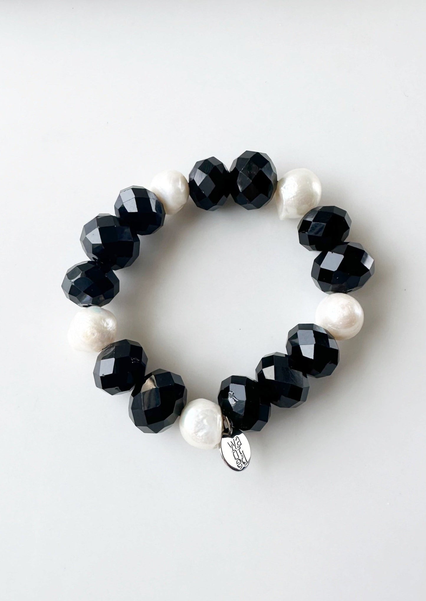 White Freshwater Pearls are joined by Black Faceted Crystals in the Stretch Bracelet.