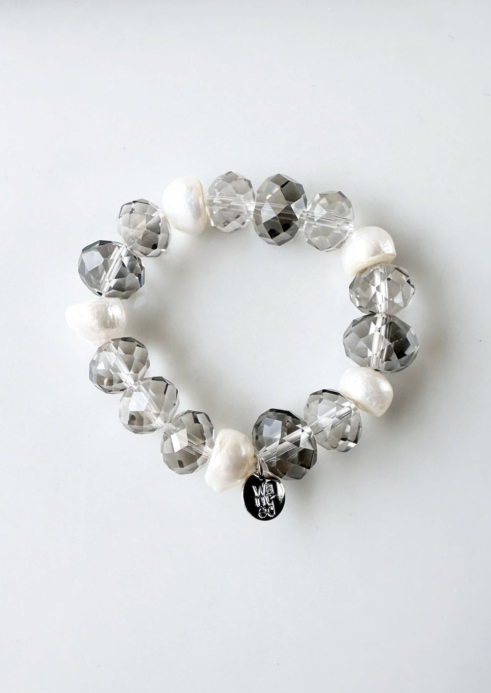 White Freshwater Pearls are joined by Smoke Faceted Crystals in the Stretch Bracelet.