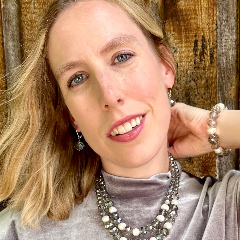 
                      
                        White Freshwater Pearls are joined by Smoke Faceted Crystals in the Stretch Bracelet. On Model with Complementary Necklace
                      
                    