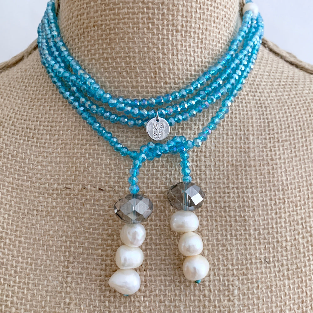 
                      
                        Long, 64-inch Lariat-Style Necklace with Blue Crystals and White Freshwater Pearls.  This Versatile piece allows it to be worn in many ways. Shown on Bust in another style
                      
                    