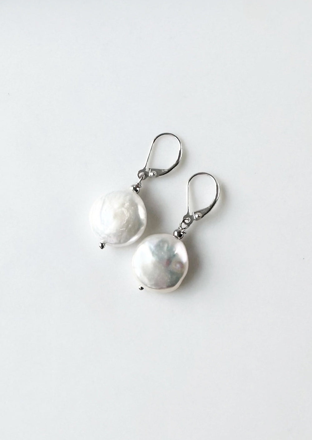 White Freshwater Coin Pearl Earrings with white crystal bead on Sterling Silver Lever backs.