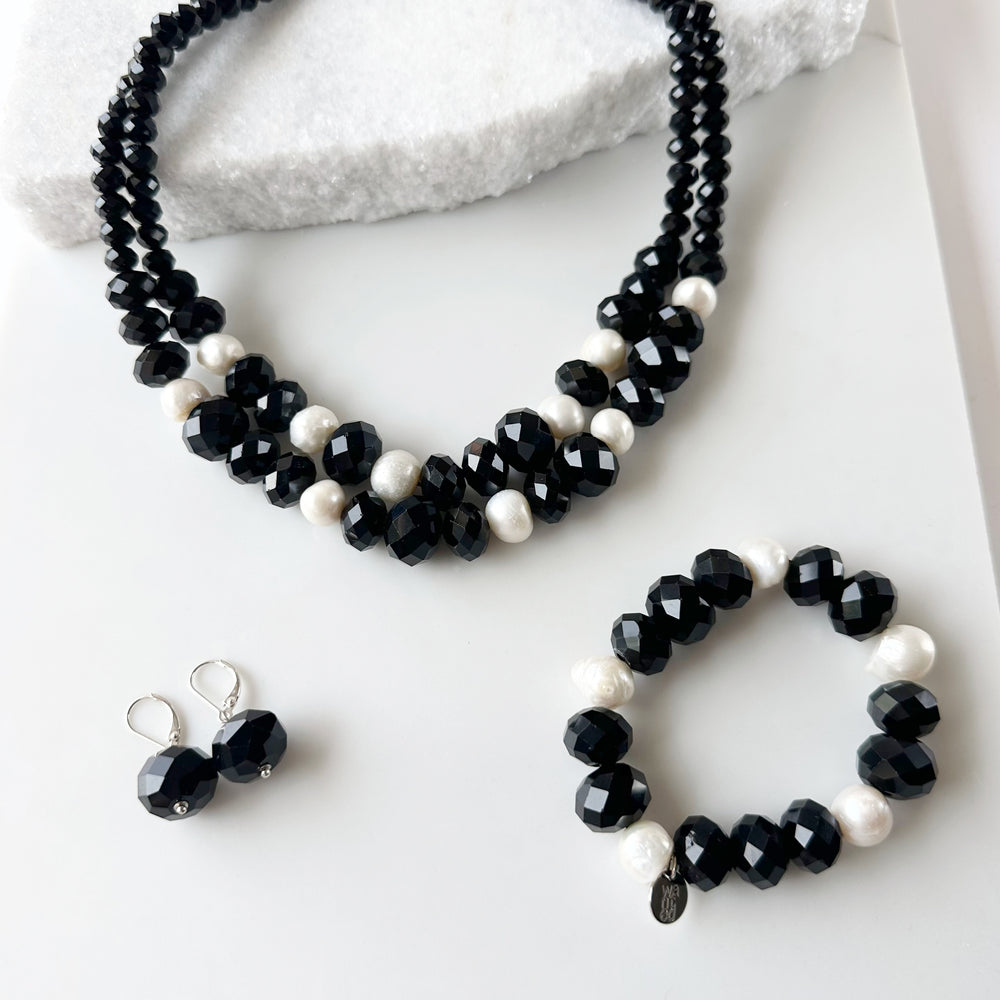 
                      
                        Two Strand White Freshwater Pearl Necklace with Large Faceted Black Crystals Joined by a Strong Secure Magnetic Clasp for Easy Wear.  Shown with Matching Bracelet and Earrings
                      
                    