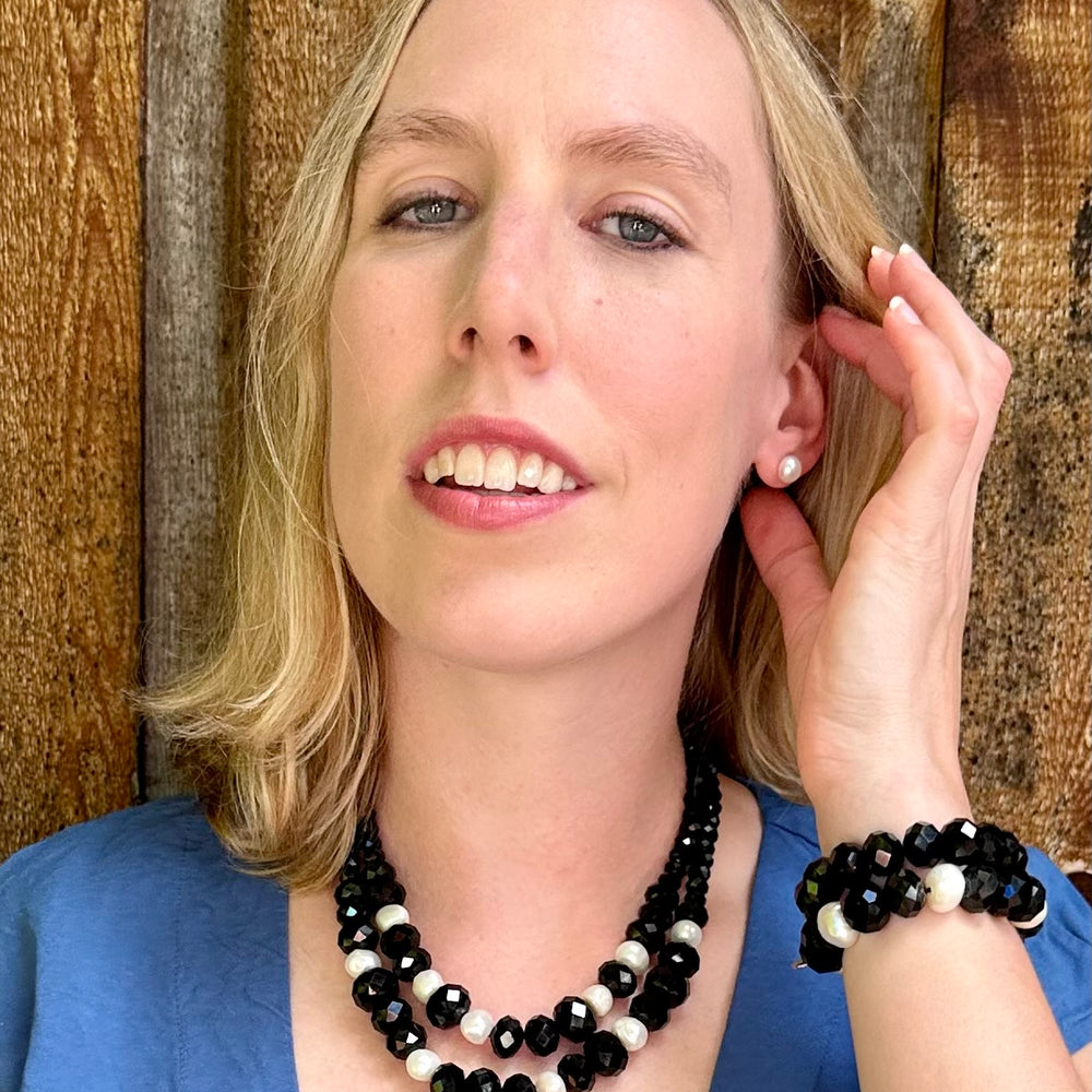 
                      
                        Two Strand White Freshwater Pearl Necklace with Large Faceted Black Crystals Joined by a Strong Secure Magnetic Clasp for Easy Wear.  Worn by Model with Matching Bracelet
                      
                    