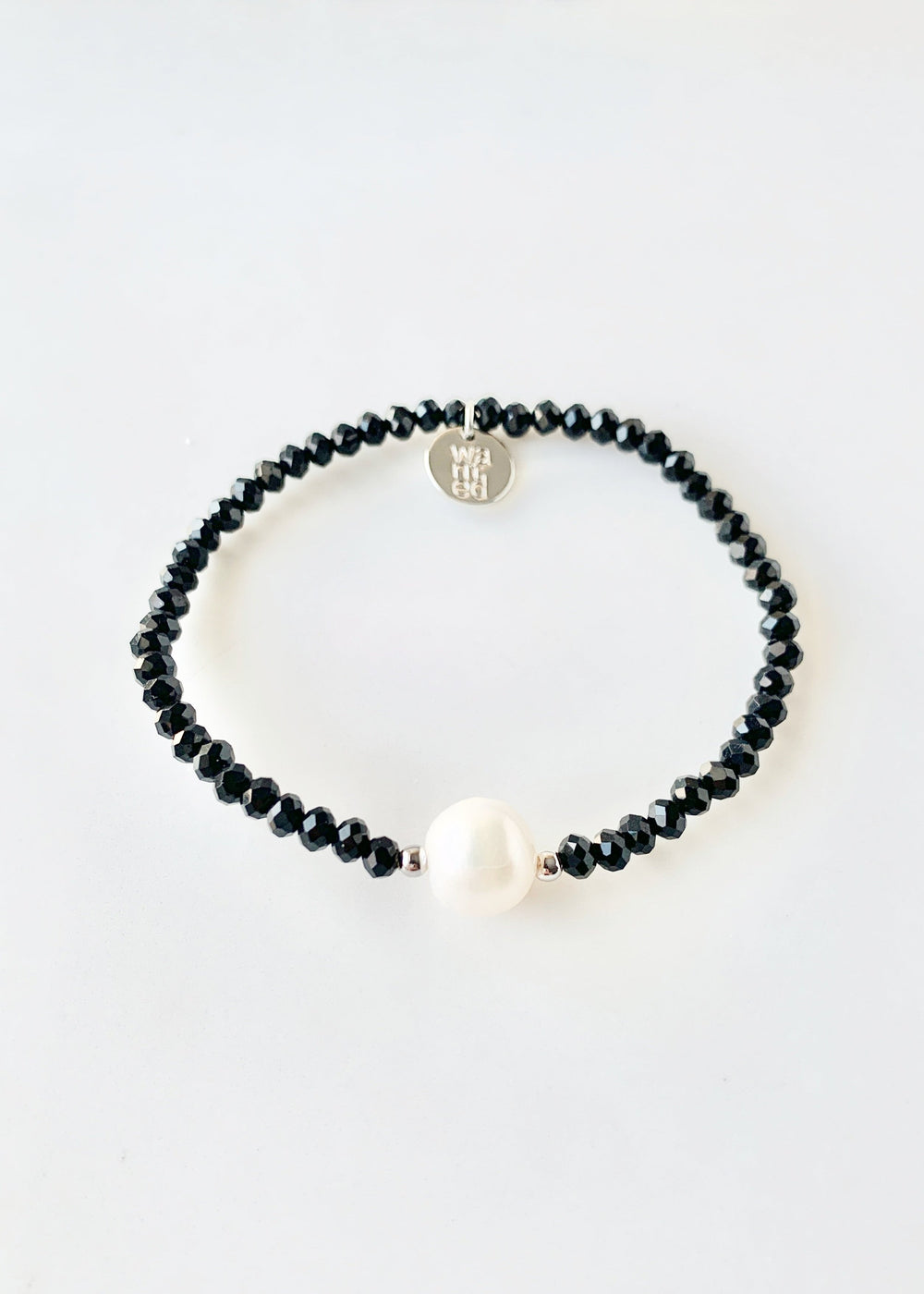 Black Faceted Crystal Bracelet with Large White Pearl Centered between two Silver Beads.