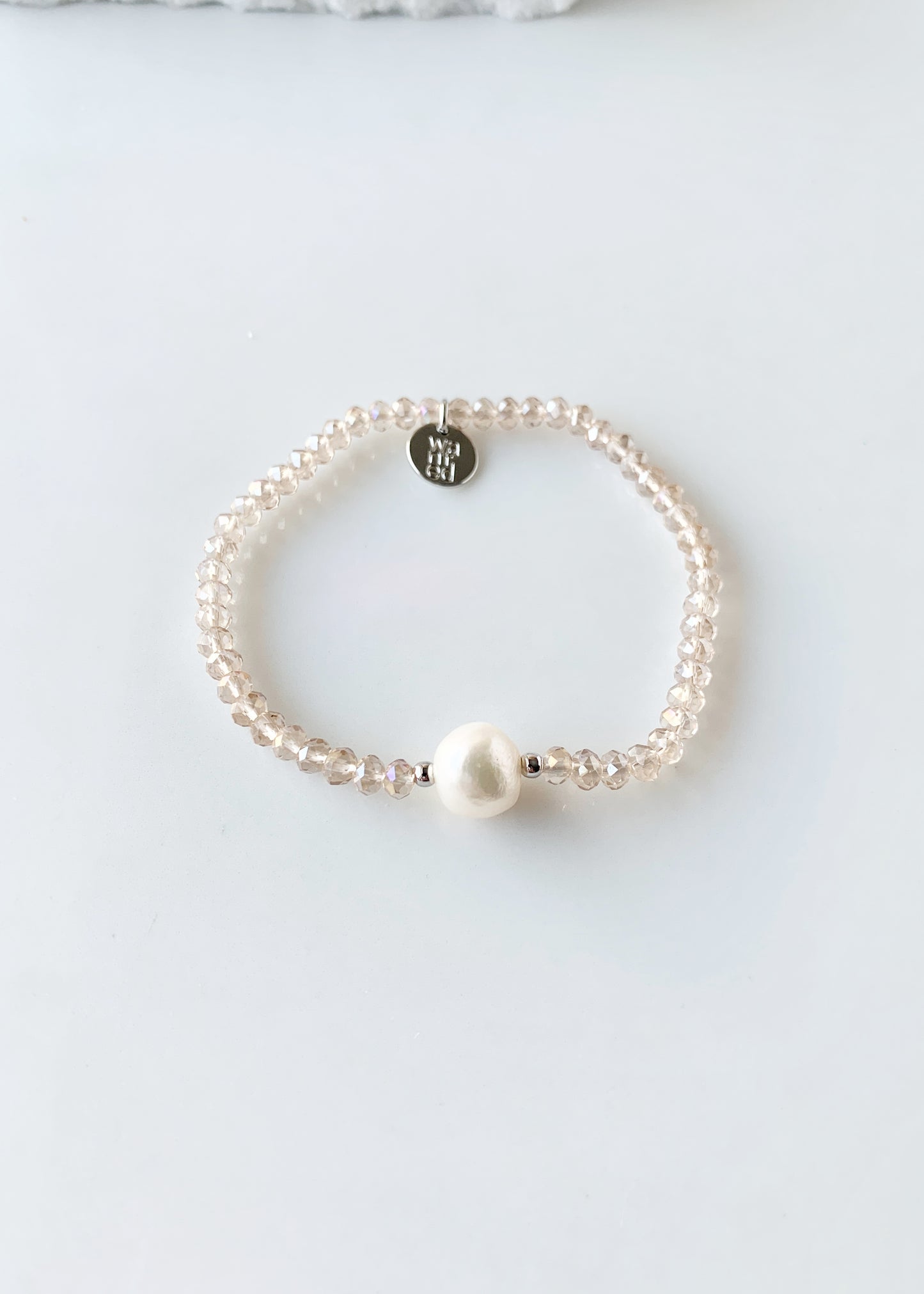 Champagne Faceted Crystal Bracelet with Large White Pearl Centered between two Silver Beads.