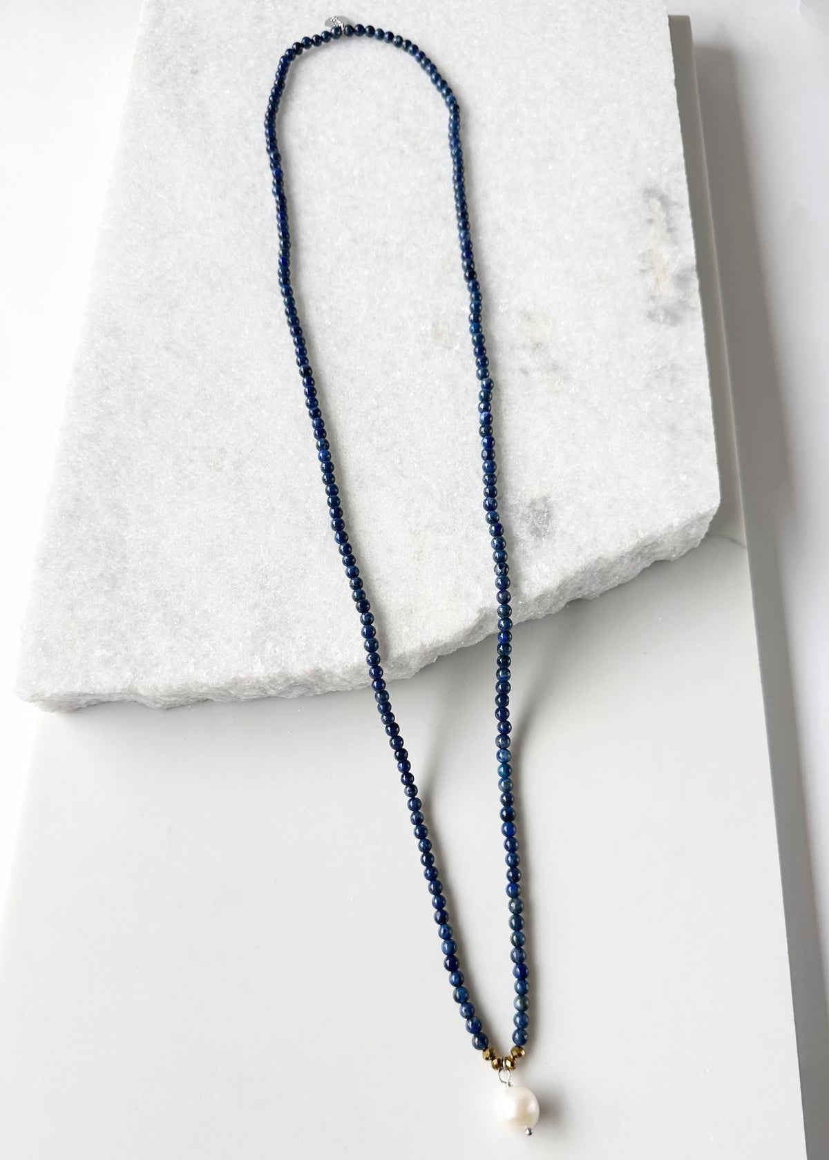 Designed in Canada, the 32” Dot Necklace is delicate simplicity with Semi-Precious Stones Accented with a touch of Crystal and a Pearl Drop. It slips on easily (no clasp) and is pretty layered  or on it's own.
