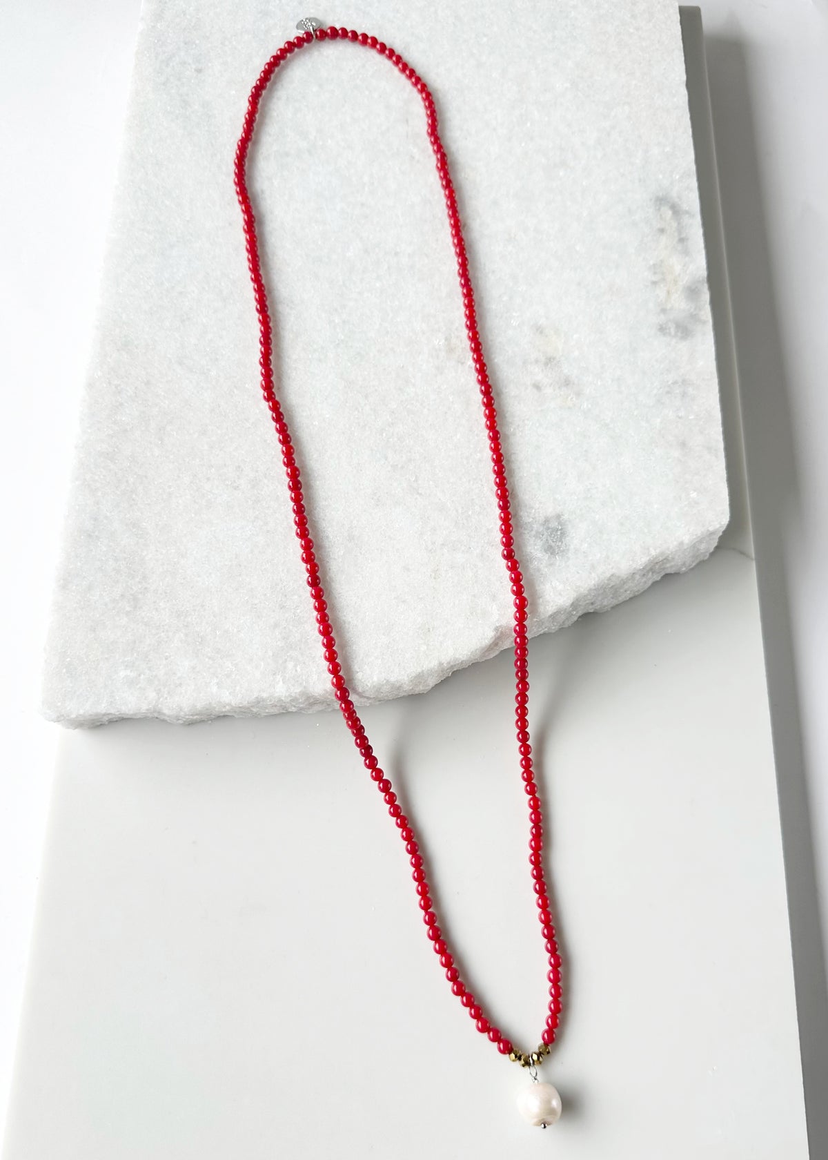 Designed in Canada, the 32” Dot Necklace is delicate simplicity with Semi-Precious Stones Accented with a touch of Crystal and a Pearl Drop. It slips on easily (no clasp) and is pretty layered  or on it's own.