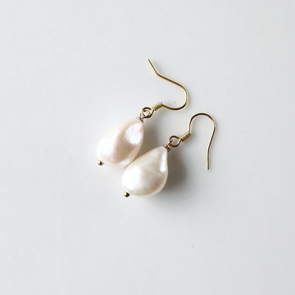 These White Baroque Freshwater Pearls drop from Gold-Plated Ear wires to complete a simple yet Elegant look.