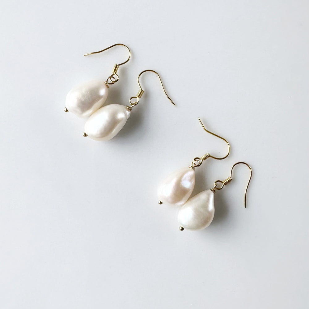 These White Baroque Freshwater Pearls drop from Gold-Plated Ear wires to complete a simple yet Elegant look. Two Pairs shown