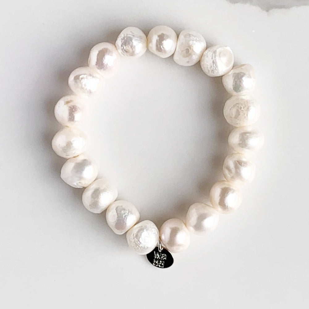 Large Baroque White Freshwater Pearls are designed in this Stretch Bracelet. This can be worn by itself or Stacked with others.