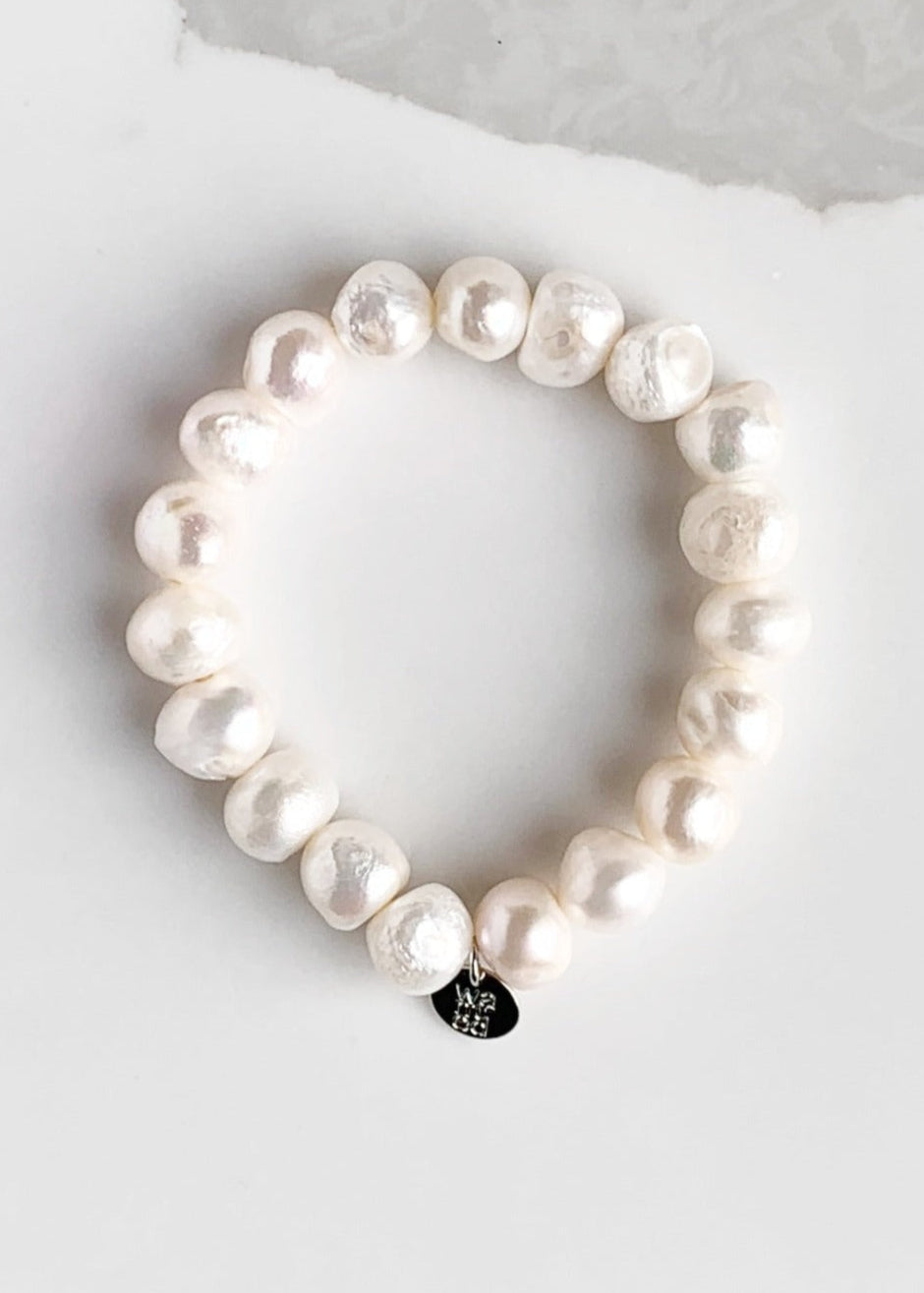 Large Baroque White Freshwater Pearls are designed in this Stretch Bracelet. This can be worn by itself or Stacked with others.