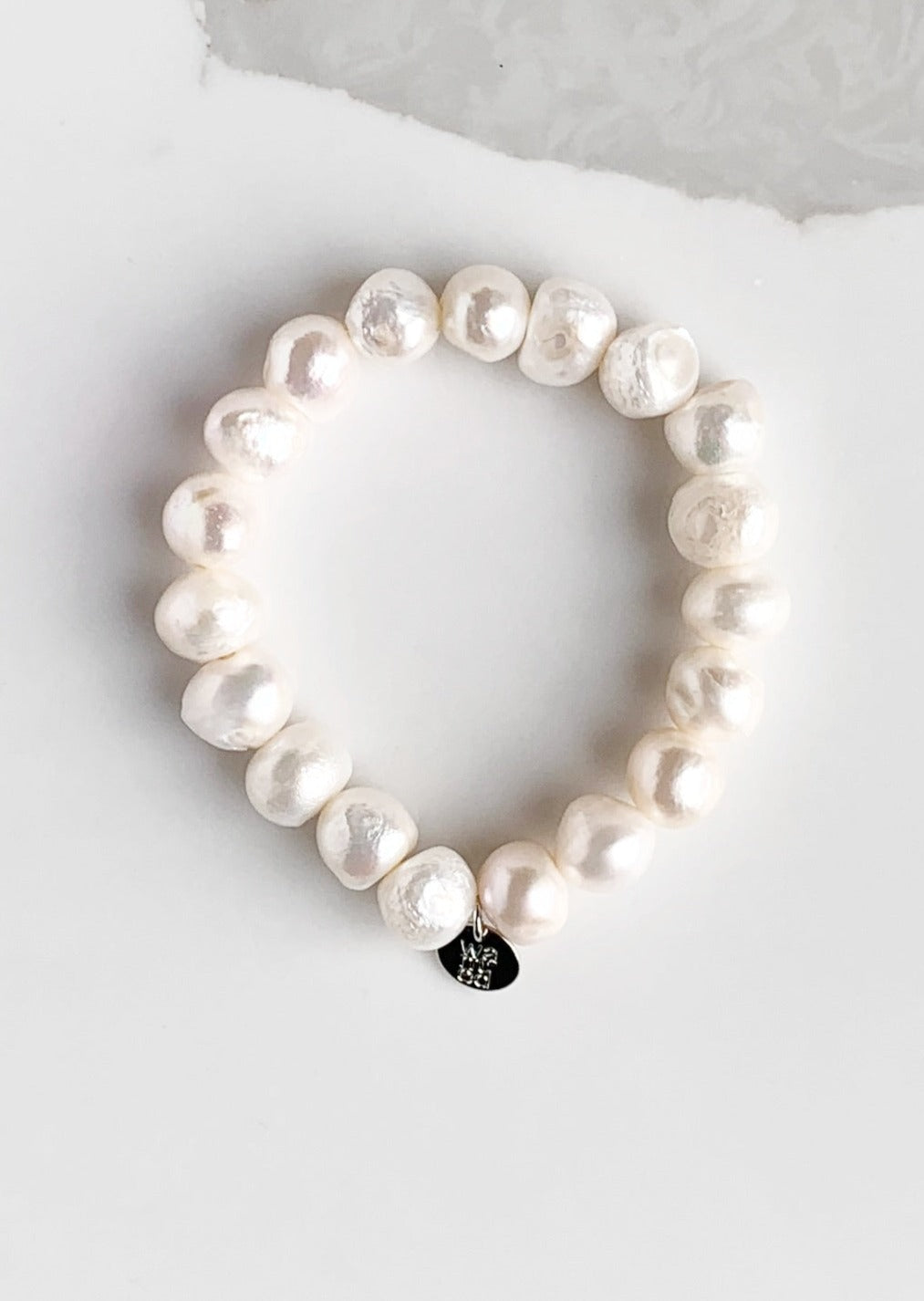 Large Baroque White Freshwater Pearls are designed in this Stretch Bracelet. This can be worn by itself or Stacked with others.