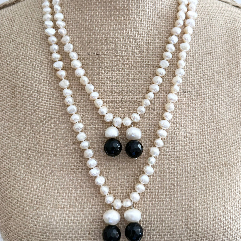 
                      
                        Long Generous White Freshwater Pearl Necklace with Larger Pearl and Black Agate drops.  Can be worn in many Styles. On Bust
                      
                    