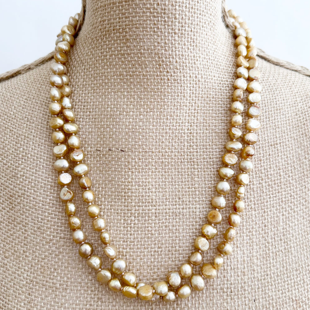 
                      
                        Long Necklace in Gold Baroque Freshwater Pearls. Wear as long Single strand or Doubled. On Bust
                      
                    