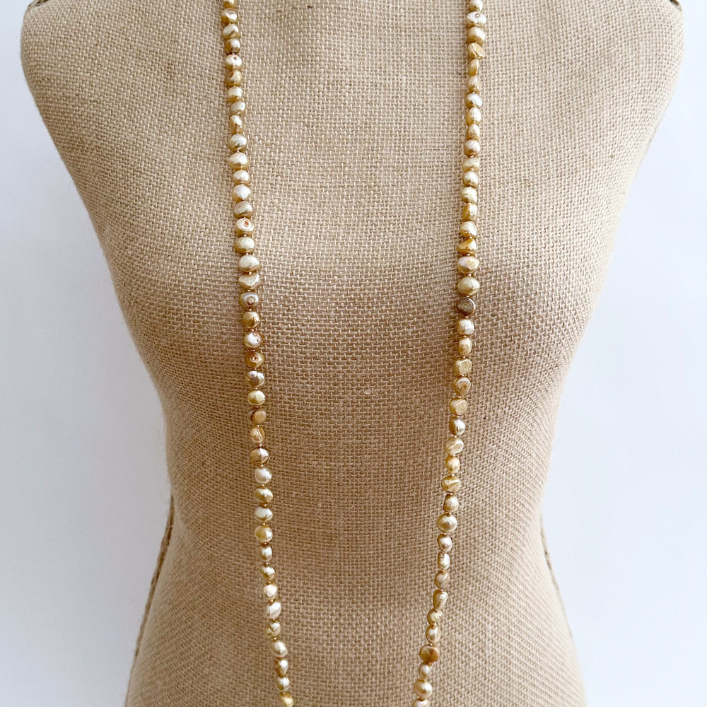
                      
                        Long Necklace in Gold Baroque Freshwater Pearls. Wear as long Single strand or Doubled.
                      
                    
