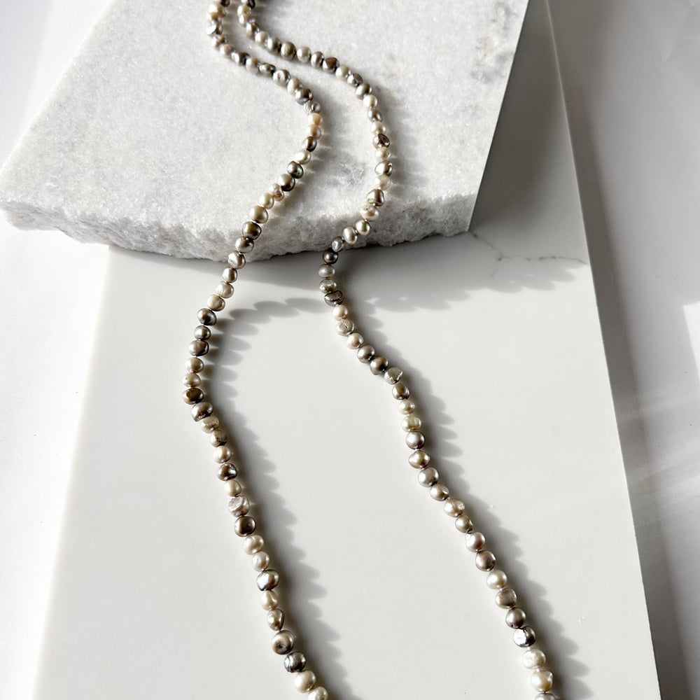 
                      
                        Long Necklace in Silver Baroque Freshwater Pearls. Wear as long Single strand or Doubled.
                      
                    