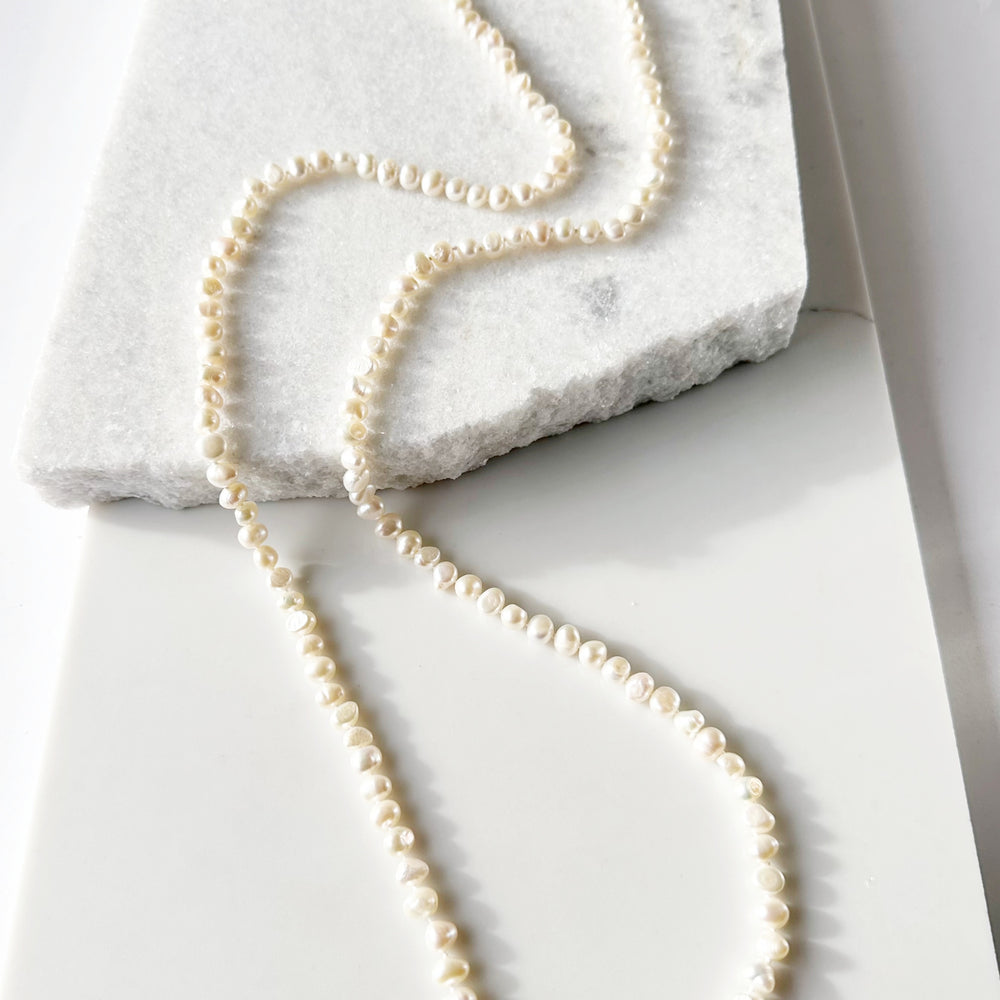 Long Necklace in White Baroque Freshwater Pearls. Wear as long Single strand or Doubled.