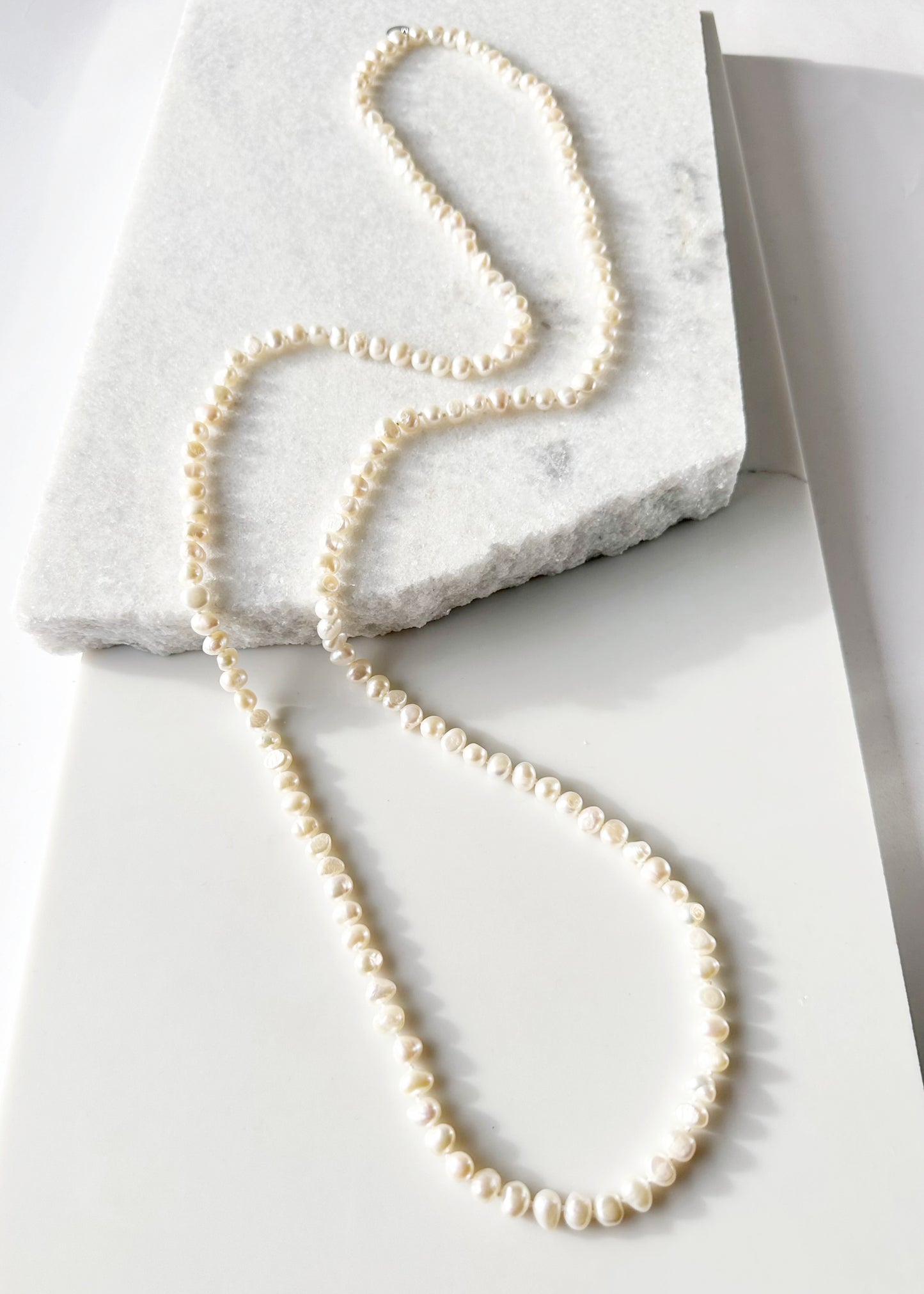 Long Necklace in White Baroque Freshwater Pearls. Wear as long Single strand or Doubled.