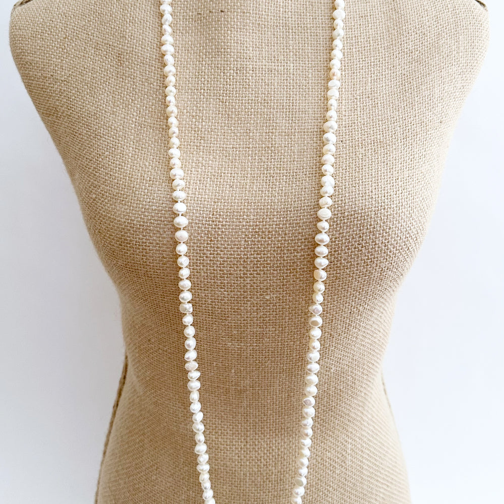 
                      
                        Long Necklace in White Baroque Freshwater Pearls. Wear as long Single strand or Doubled. On Bust
                      
                    