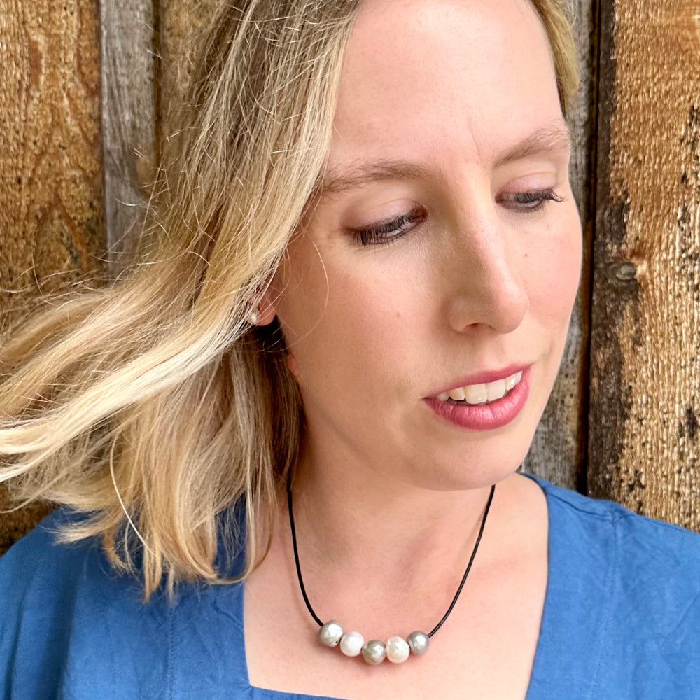 
                      
                        Five Large Silver and White Freshwater Pearls Floating on Black Leather secured by a Strong Magnetic Clasp for Easy wear. On Model
                      
                    