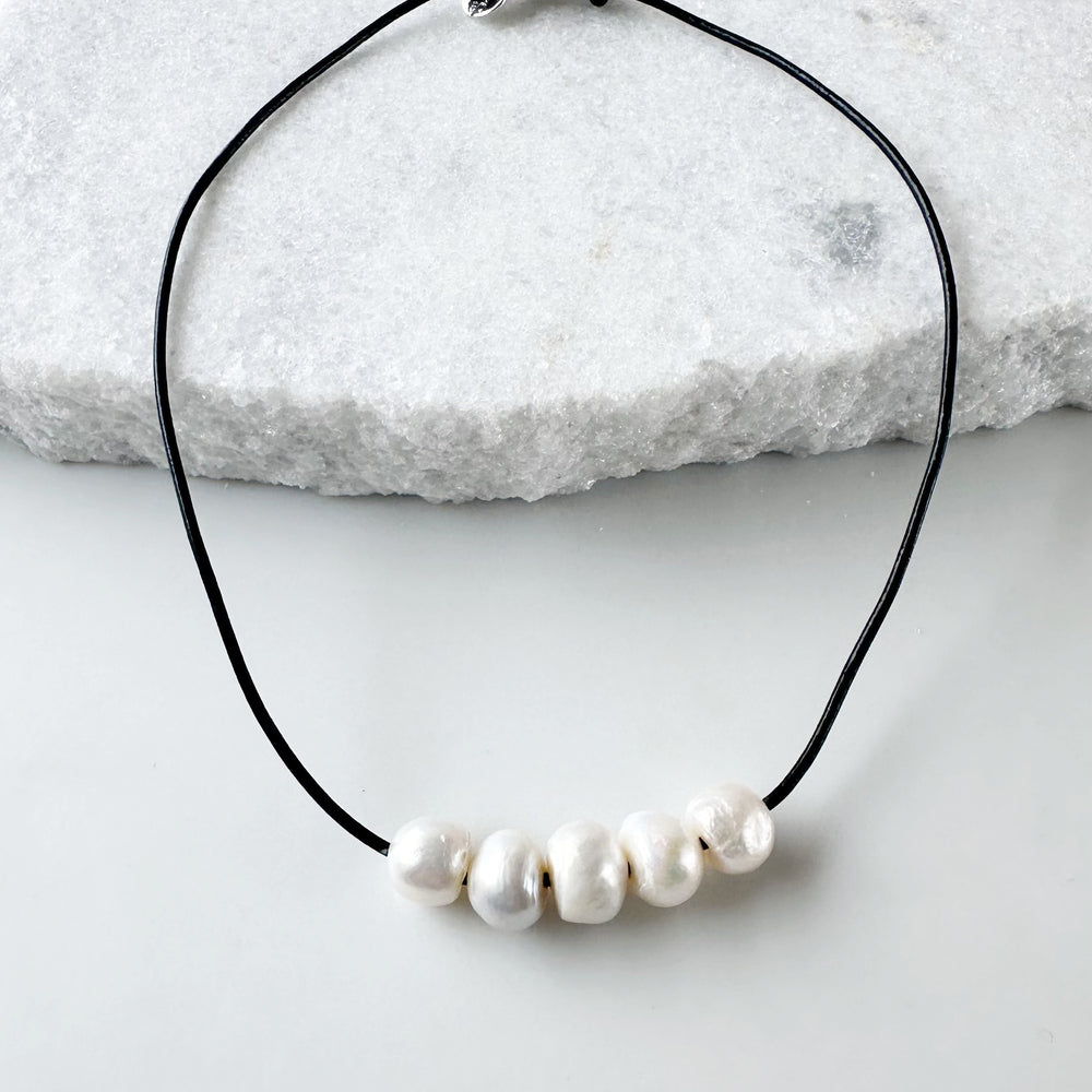 Five Large White Freshwater Pearls Floating on Black Leather secured by a Strong Magnetic Clasp for Easy wear.