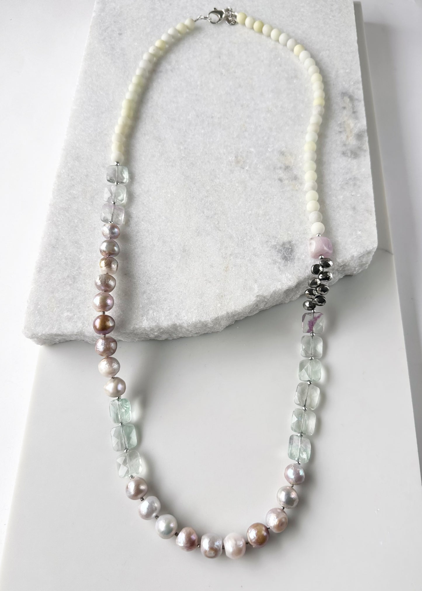 Designed and Made in Canada, this Gorgeous One-Of-A-Kind 36” Necklace features Faceted, Square, Light, Green Fluorite, Pink Kunzite, Jasper, Hematite and Large Pink Pearls finished with a Large lobster Claw Clasp.  Wear it long or doubled.