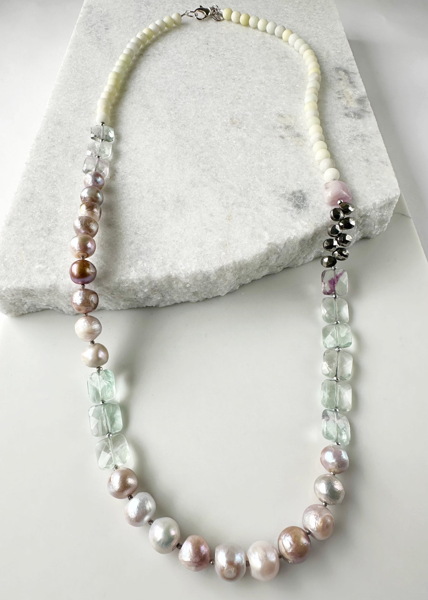 Designed and Made in Canada, this Gorgeous One-Of-A-Kind 36” Necklace features Faceted, Square, Light, Green Fluorite, Pink Kunzite, Jasper, Hematite and Large Pink Pearls finished with a Large lobster Claw Clasp.  Wear it long or doubled.