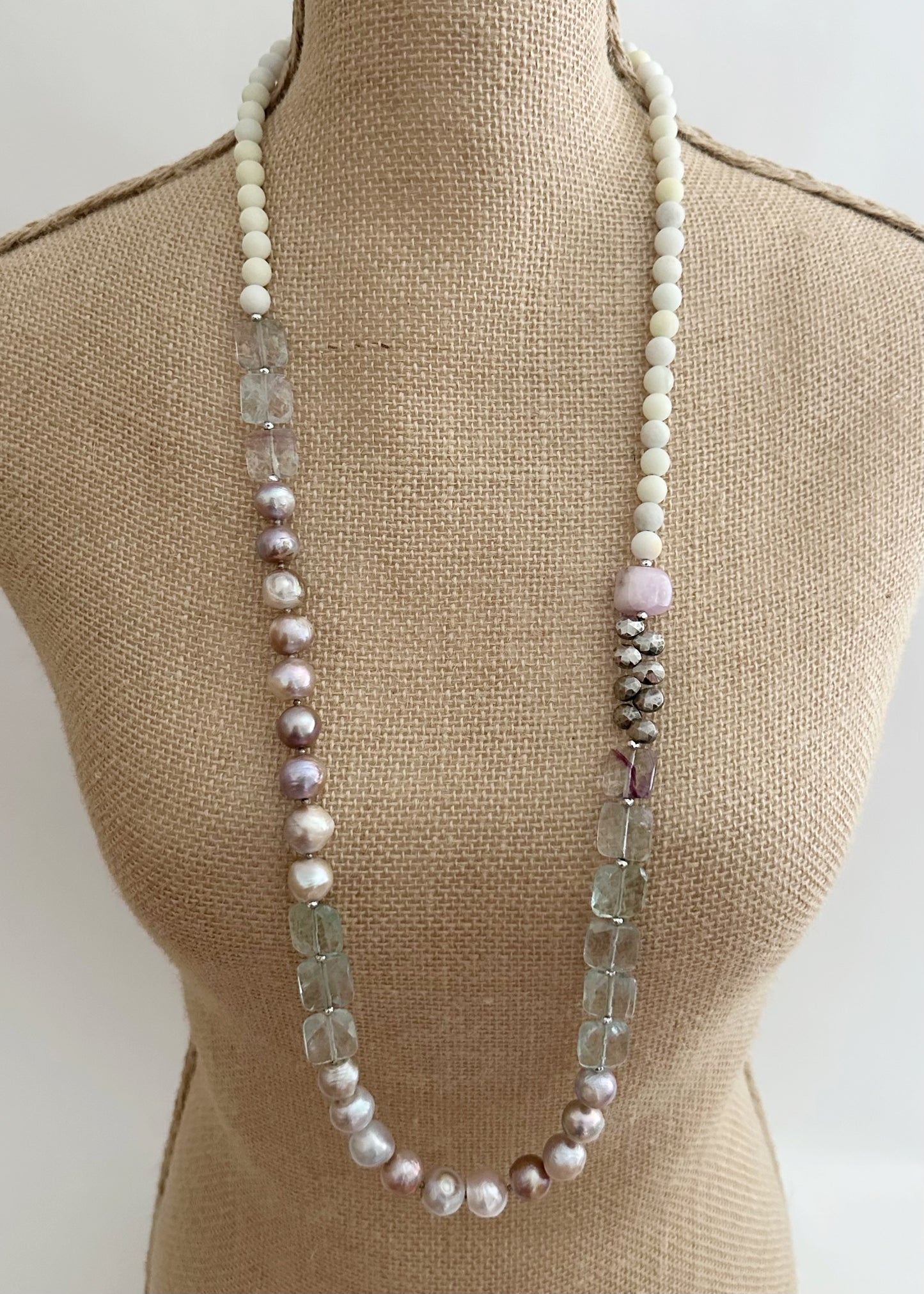 Designed and Made in Canada, this Gorgeous One-Of-A-Kind 36” Necklace features Faceted, Square, Light, Green Fluorite, Pink Kunzite, Jasper, Hematite and Large Pink Pearls finished with a Large lobster Claw Clasp.  Wear it long or doubled.