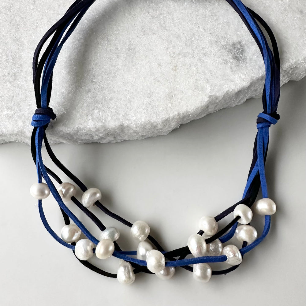 Five Strands of Blue and Black Vegan Suede with Floating White Freshwater Pearls are Offered with a Strong Secure Magnetic Clasp for Easy Wear.