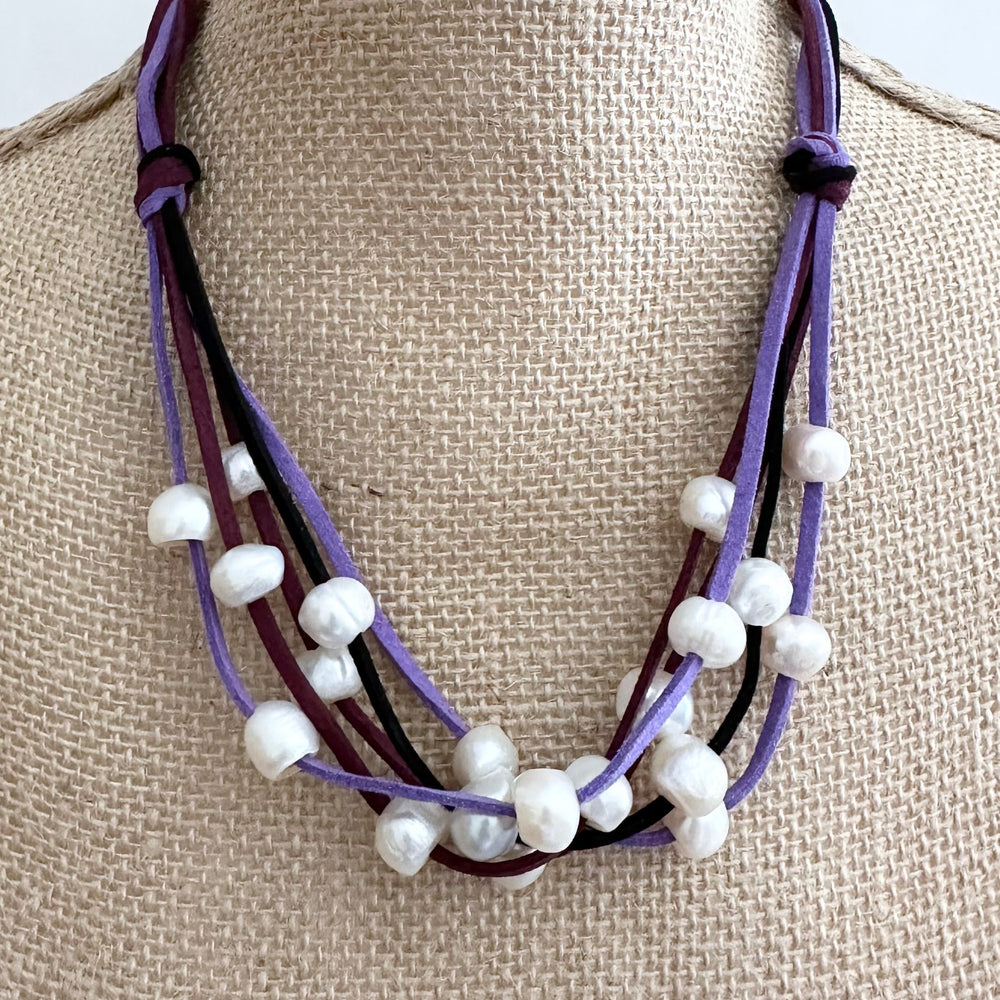
                      
                        Five Strands of Purple Vegan Suede with Floating White Freshwater Pearls are Offered with a Strong Secure Magnetic Clasp for Easy Wear.
                      
                    