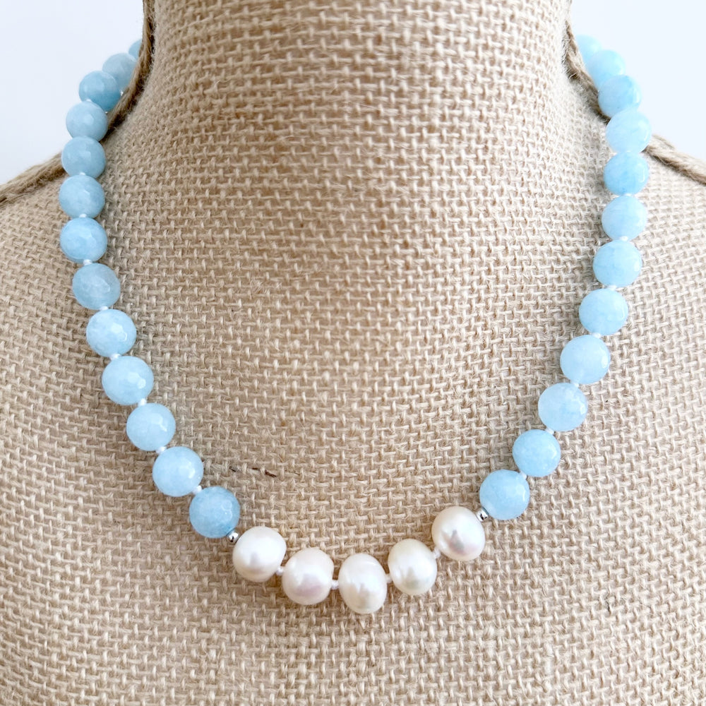 
                      
                        White Freshwater Baroque Pearls Strung with Faceted Blue Semi-Precious Stones with a Pretty Carved Shell Flower Hanging from a Gold-Plated Rectangular Clasp for a 18.5” Necklace.  This Necklace can be worn in Various ways.
                      
                    
