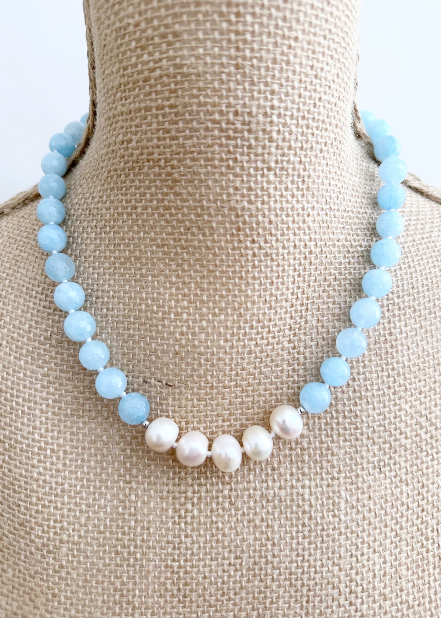 White Freshwater Baroque Pearls Strung with Faceted Blue Semi-Precious Stones with a Pretty Carved Shell Flower Hanging from a Gold-Plated Rectangular Clasp for a 18.5” Necklace.  This Necklace can be worn in Various ways.