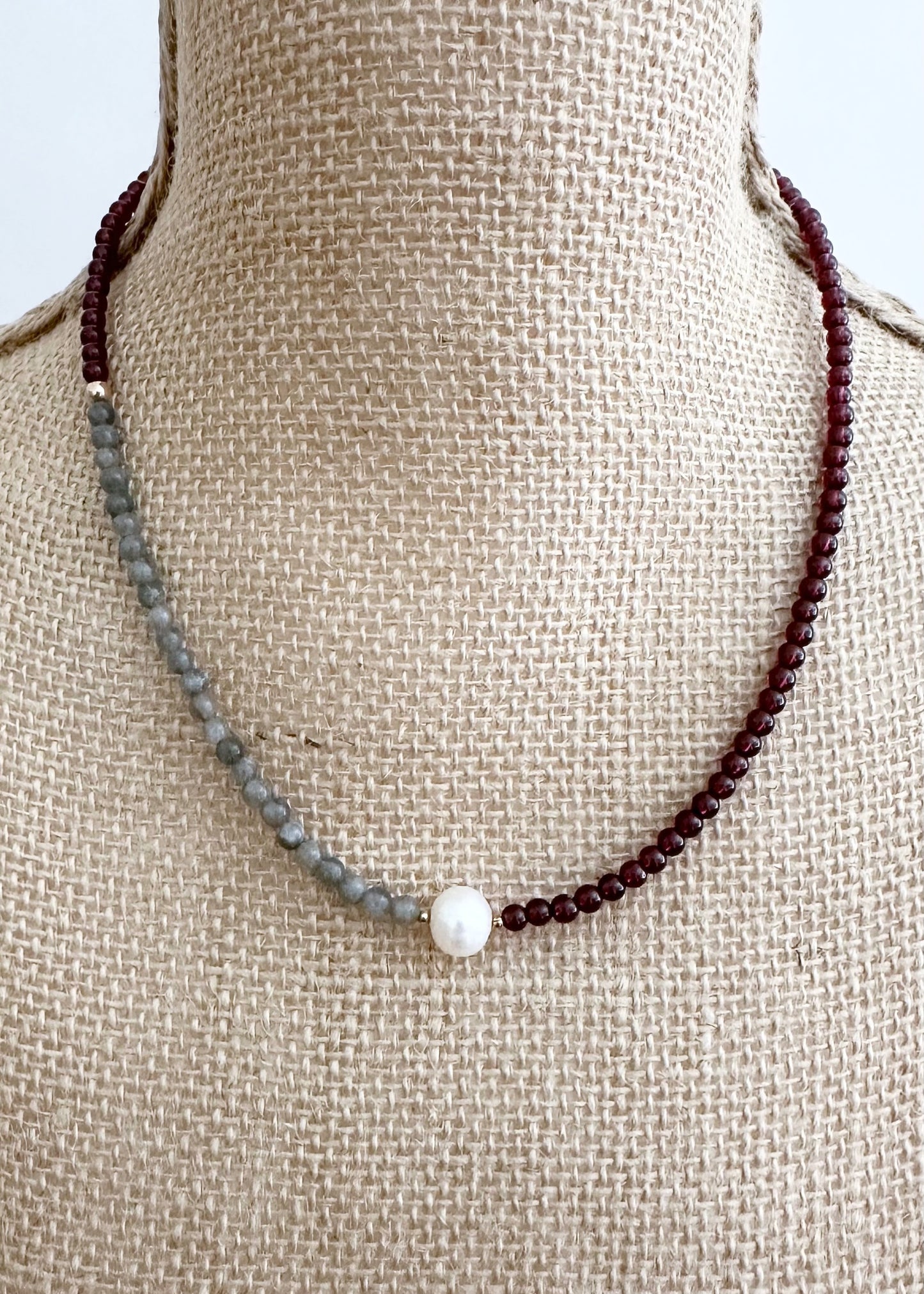 This 18.5" Limited-Edition Necklace, features Rich A+ Mozambique Garnet(4mm), Iridescent A+ Labradorite(4mm), and a Lustrous White A+ Pearl with Gold Accents. Designed and made in Canada, this piece is completed with a Gold-Filled Spring Ring Clasp.