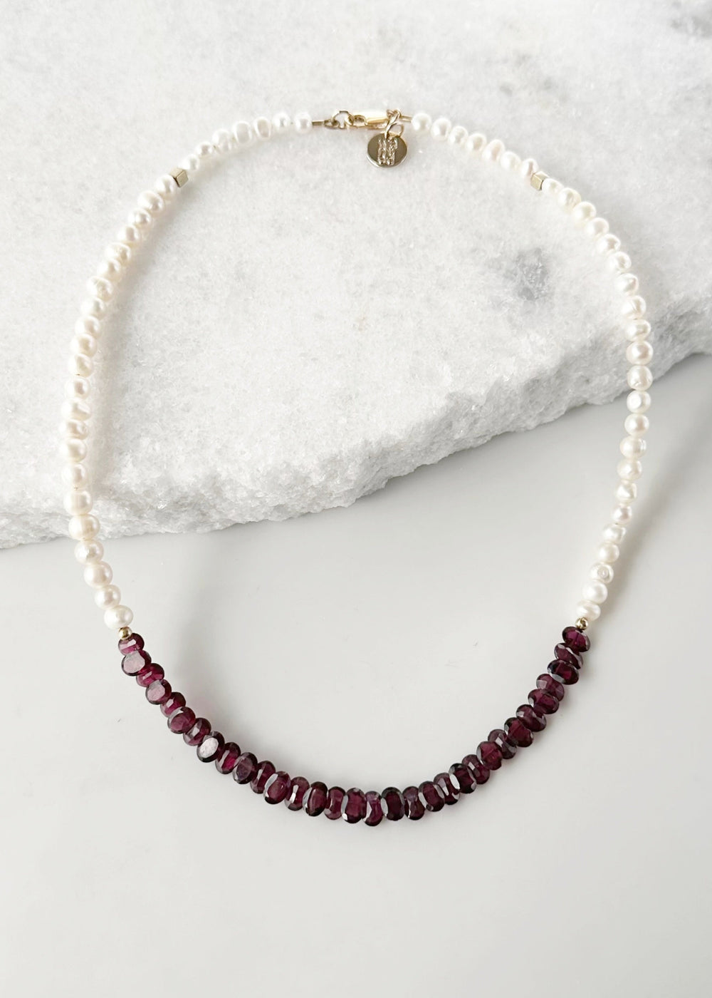 Designed and made in Canada, this one-of-a-kind 18” Necklace features Beautiful Oval-Faceted 7mm Garnets and White Freshwater Pearls Accented with Gold and Finished with a Gold-Filled Lobster Claw clasp.