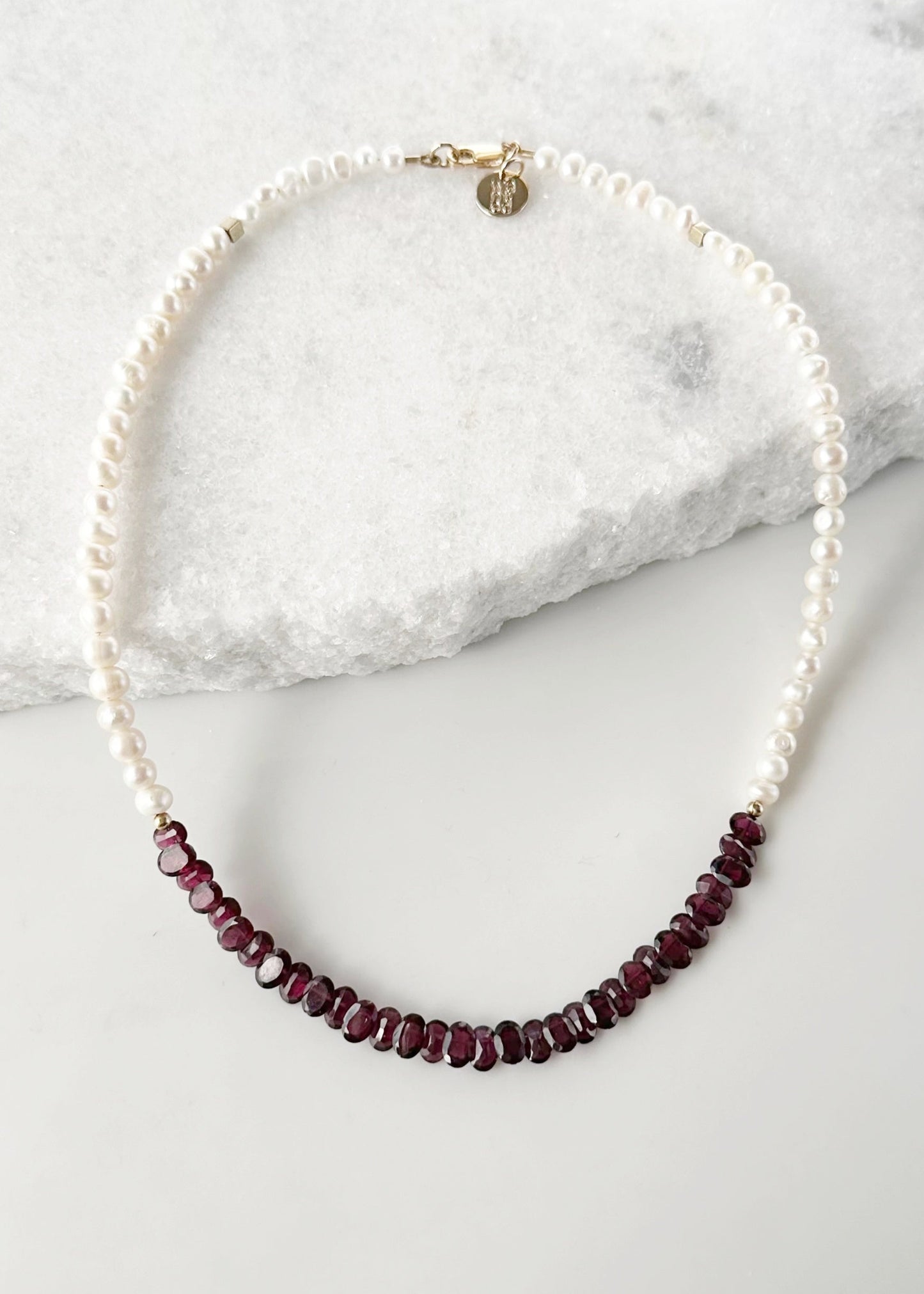 Designed and made in Canada, this one-of-a-kind 18” Necklace features Beautiful Oval-Faceted 7mm Garnets and White Freshwater Pearls Accented with Gold and Finished with a Gold-Filled Lobster Claw clasp.