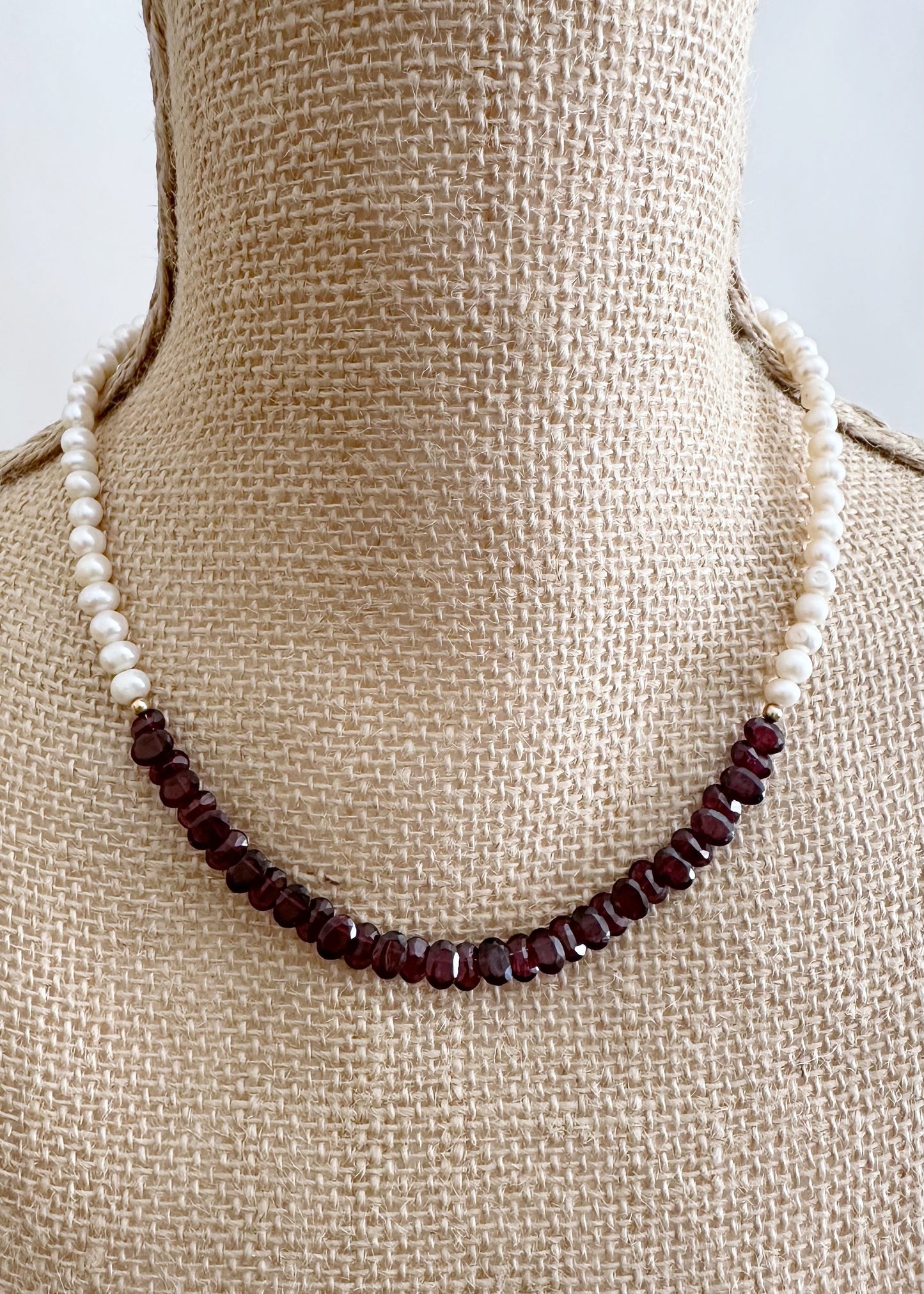 Designed and made in Canada, this one-of-a-kind 18” Necklace features Beautiful Oval-Faceted 7mm Garnets and White Freshwater Pearls Accented with Gold and Finished with a Gold-Filled Lobster Claw clasp.