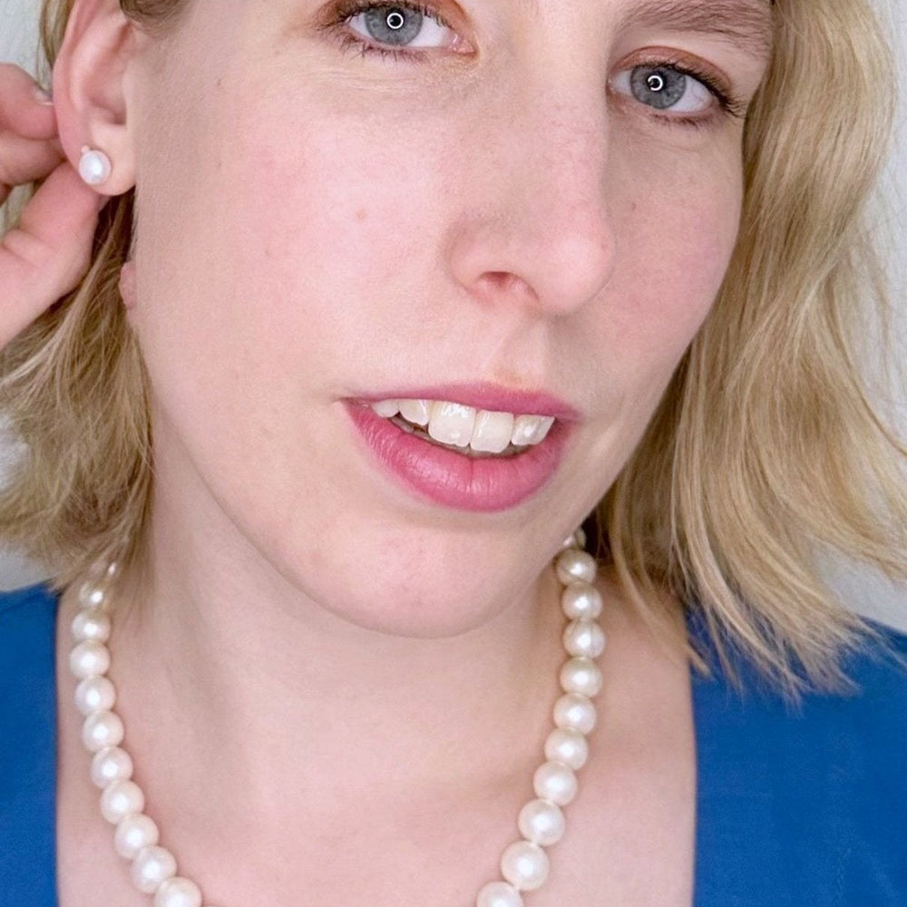 
                      
                        Large (11-12mm) Lustrous White Freshwater Pearl Necklace with Bean Clasp for Easy Wear. On Model
                      
                    
