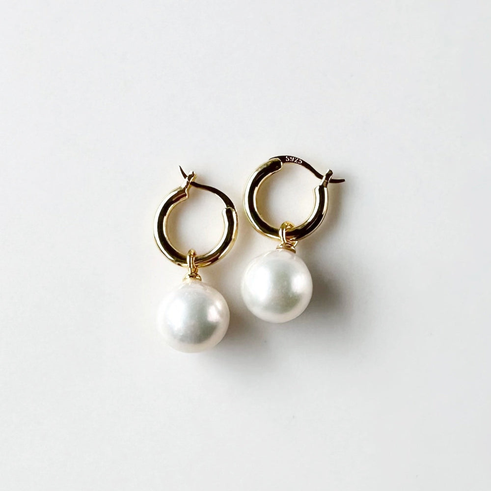 These Earrings feature Stunning Large (10-11mm) White Freshwater Pearls Elegantly Paired with Gold-Plated Hoops.