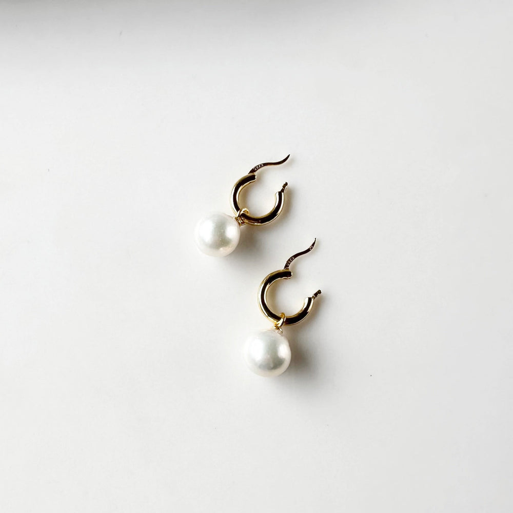 These Earrings feature Stunning Large (10-11mm) White Freshwater Pearls Elegantly Paired with Gold-Plated Hoops.