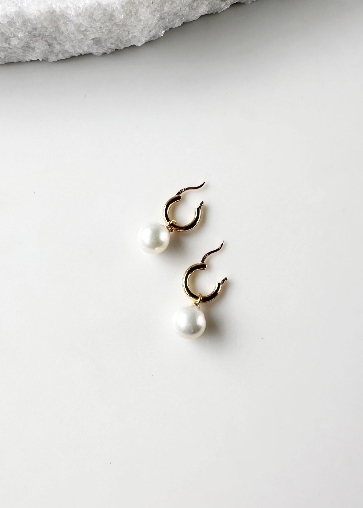 These Earrings feature Stunning Large (10-11mm) White Freshwater Pearls Elegantly Paired with Gold-Plated Hoops.