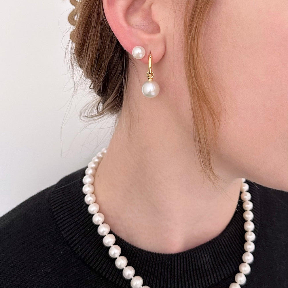 
                      
                        These Earrings feature Stunning Large (10-11mm) White Freshwater Pearls Elegantly Paired with Gold-Plated Hoops.
                      
                    