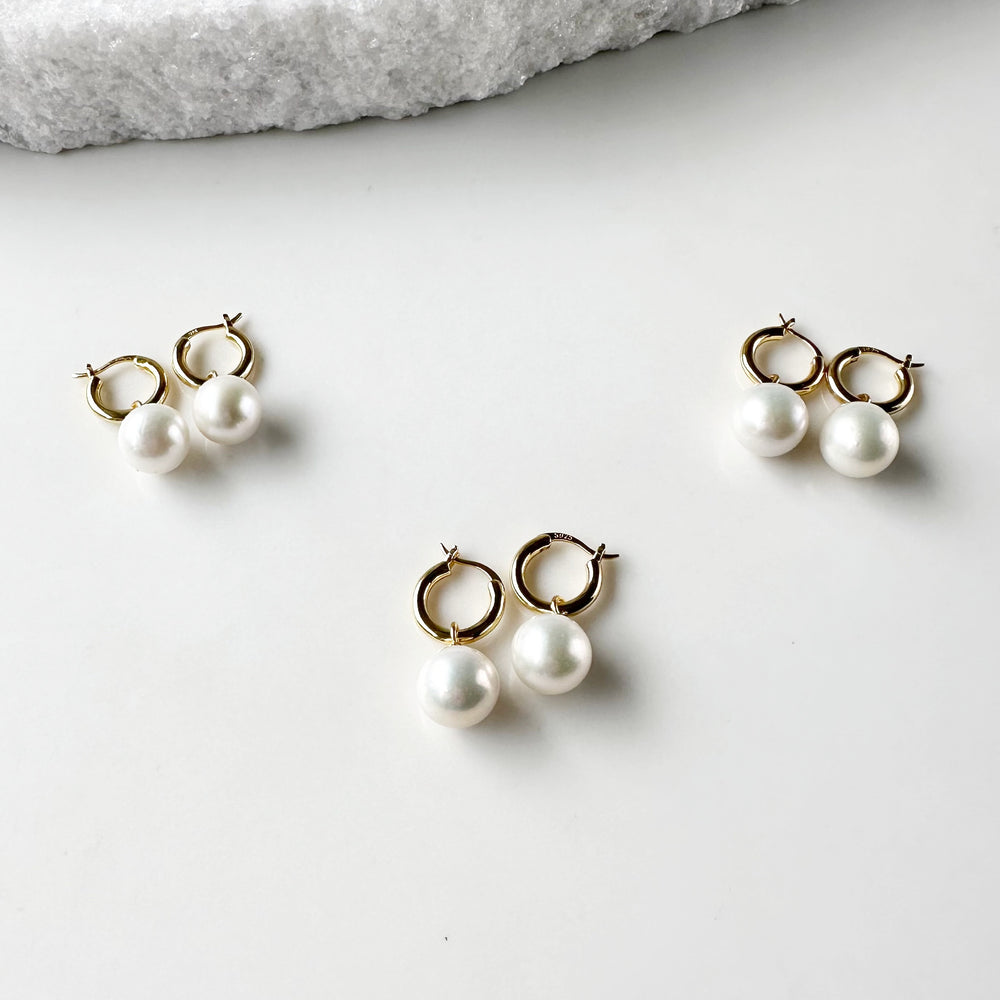 
                      
                        These Earrings feature Stunning Large (10-11mm) White Freshwater Pearls Elegantly Paired with Gold-Plated Hoops.
                      
                    