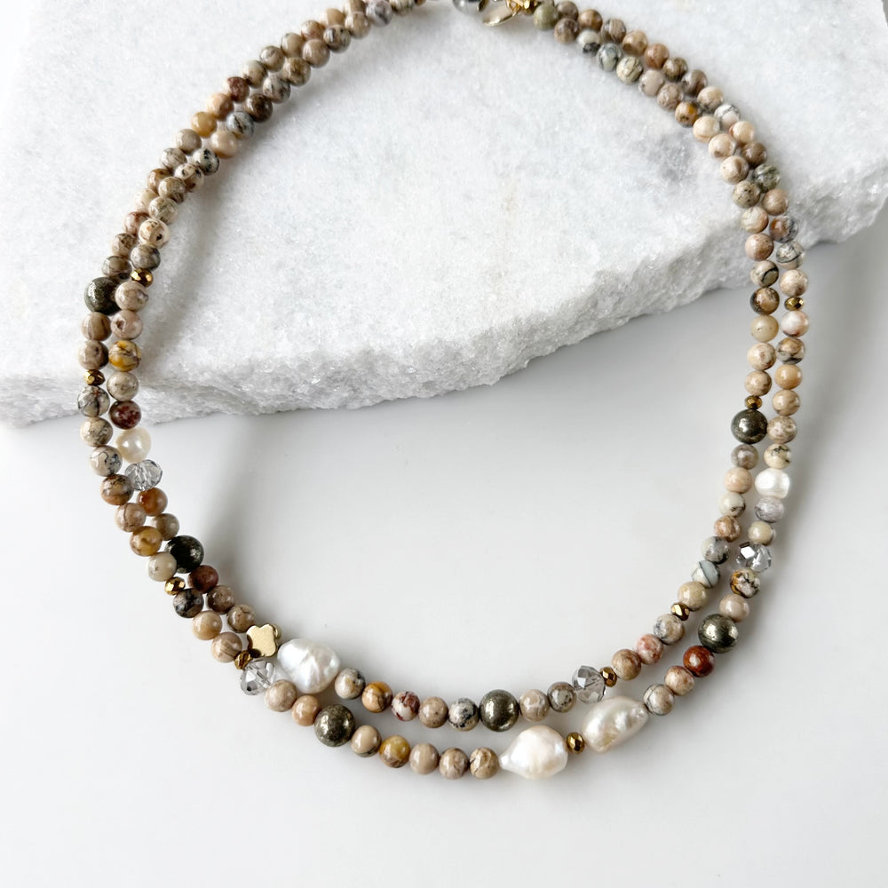 This Two-Strand (Inner Length of 19”) Necklace Features White African Opal and Freshwater Pearls Accented with Pyrite, Faceted Crystal and Gold-Plated Hematite for a soft elegant touch. Finished with a Magnetic Clasp for Easy Wear. Designed and made in Canada