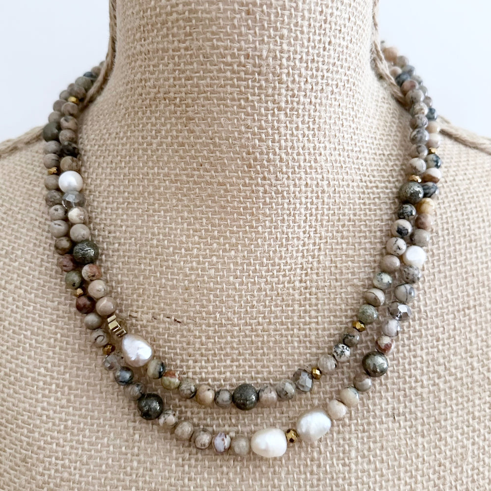 This Two-Strand (Inner Length of 19”) Necklace Features White African Opal and Freshwater Pearls Accented with Pyrite, Faceted Crystal and Gold-Plated Hematite for a soft elegant touch. Finished with a Magnetic Clasp for Easy Wear. Designed and made in Canada